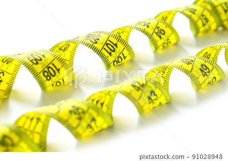 Yellow measuring measure tape isolated on white background Yellow measuring measure tape isolated on white background 91028948