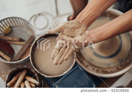 Top Down View on Hands Greased in a Clay, Pottery Master at Work Top Down View on Hands Greased in a Clay, Pottery Master at Work 91029088