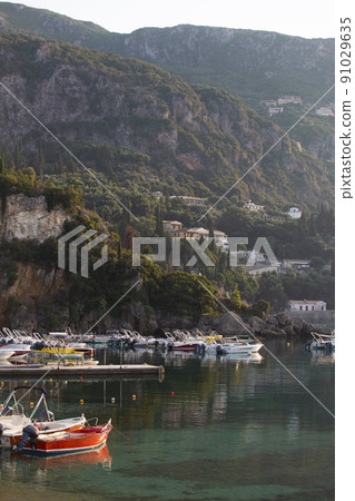 boats in the bay of Paleokastritsa at dawn 91029635