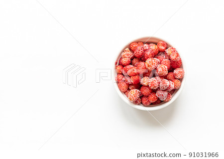 Frozen red wild forest strawberry in white bowl on white background with copy space for text. Freezing berries are healthy, they contains all vitamins. Top view. Horizontal orientation. 91031966