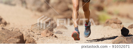 Trail running man on mountain path exercising 91032071