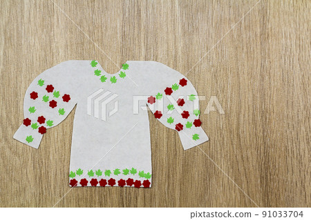 White paper women blouse on wooden background White paper women blouse on wooden background 91033704