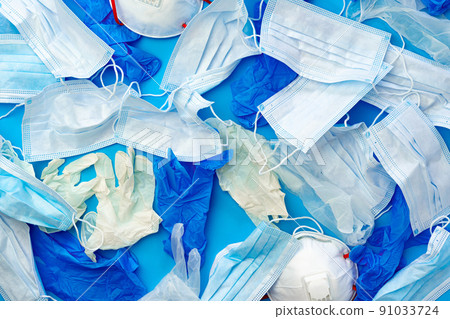 Coronavirus protection equipment in medical waste bin. Used face masks and sterile gloves. Coronavirus protection equipment in medical waste bin. Used face masks and sterile gloves. 91033724