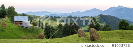 Village houses on hills with green meadows in summer day. House of shepherds in mountains in carpathian Village houses on hills with green meadows in summer day. House of shepherds in mountains in carpathian 91033726