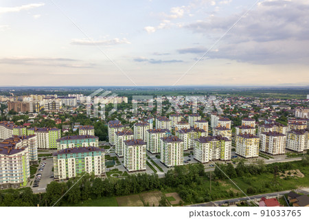 Top view of urban developing city landscape with tall apartment buildings and suburb houses. Drone aerial photography. Top view of urban developing city landscape with tall apartment buildings and suburb houses. Drone aerial photography. 91033765