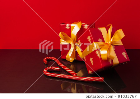 Several stacked Christmas gifts in festive wrapping Several stacked Christmas gifts in festive wrapping 91033767