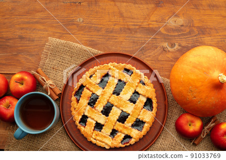 Homemade traditional sweet autumn tart pie on wooden table Homemade traditional sweet autumn tart pie on wooden table 91033769