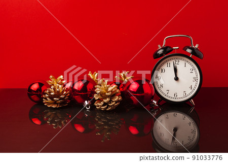 Red Christmas balls and golden painted cones against red background Red Christmas balls and golden painted cones against red background 91033776