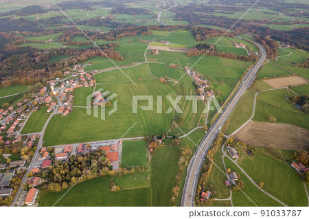 Top down aerial view of freeway interstate road with moving traffic cars in rural area. Top down aerial view of freeway interstate road with moving traffic cars in rural area. 91033787