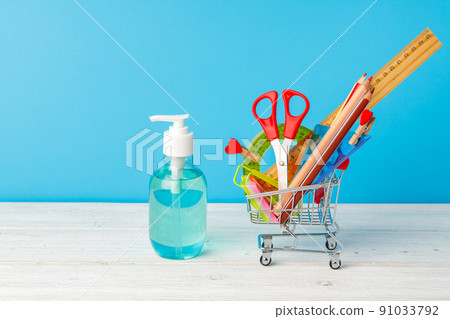 School supplies and hand sanitizer. Pandemic education concept School supplies and hand sanitizer. Pandemic education concept 91033792