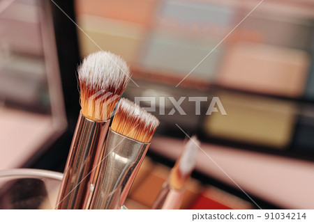 decorative cosmetics on pink background. close up 91034214