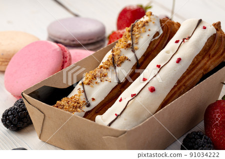 Fresh eclair cakes in a cardboard box 91034222