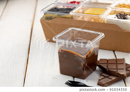 Assortment of delicious dessert boxes on wooden table 91034350