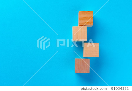 Top view of wooden toy blocks on blue Top view of wooden toy blocks on blue 91034351