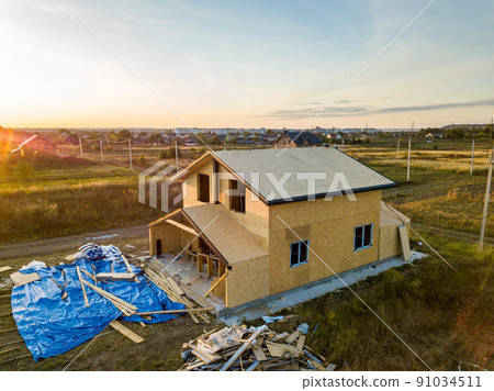 Construction of new and modern modular house. Walls made from composite wooden sip panels with styrofoam insulation inside. Building new frame of energy efficient home concept. 91034511