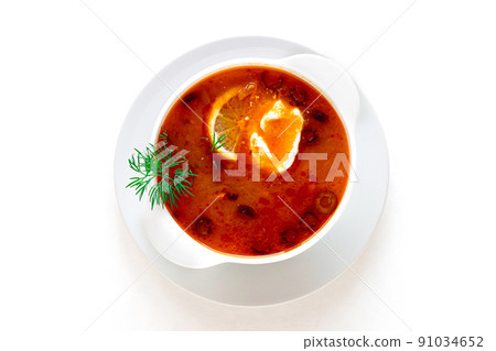 Traditional Russian meat soup Solyanka in bowl isolated on white background. A great product for your menu. Traditional Russian meat soup Solyanka in bowl isolated on white background. A great product for your menu. 91034652