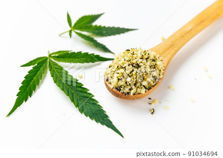 Green cannabis leaves and spoon with peeled off seeds isolated on white background. nutritional legal usage of marijuana. Omega 3 fats. Superfood Green cannabis leaves and spoon with peeled off seeds isolated on white background. nutritional legal usage of marijuana. Omega 3 fats. Superfood 91034694