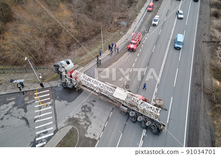 Aerial view of road accident with overturned truck blocking traffic 91034701