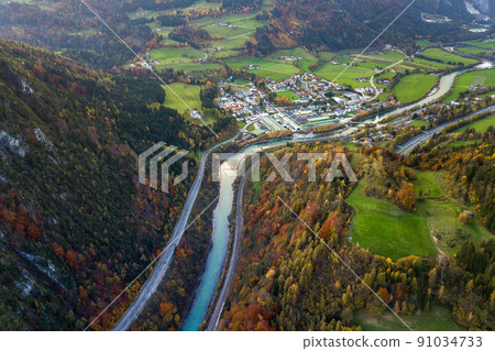Aerial view of green meadows with villages and forest in austrian Alps mountains. Aerial view of green meadows with villages and forest in austrian Alps mountains. 91034733