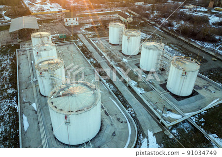 Aerial view of big fuel reservoires in petrol industrial zone in winter. Aerial view of big fuel reservoires in petrol industrial zone in winter. 91034749