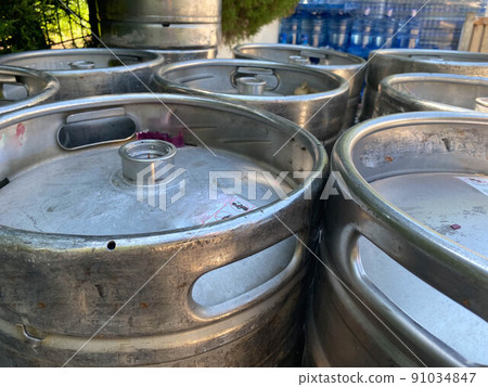 metal barrels at a construction site. large containers for liquid and bulk materials. safety of barrels at the construction site. rust gray glossy paint 91034847