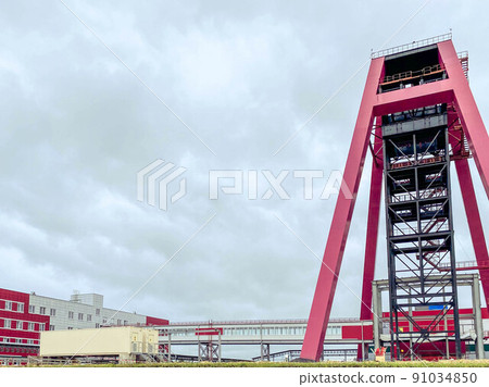 construction site of an industrial complex. construction of a mine for mining. red metal structure for digging into a mine, digging a ditch 91034850