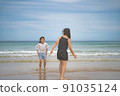 Children playing in the sea 91035124