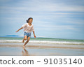 Children playing in the sea 91035140