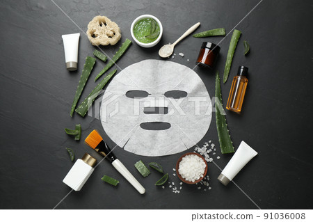 Flat lay composition with different cosmetic products and aloe on black table 91036008