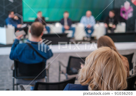 Anonymous people listening to speakers on stage during forum Anonymous people listening to speakers on stage during forum 91036203