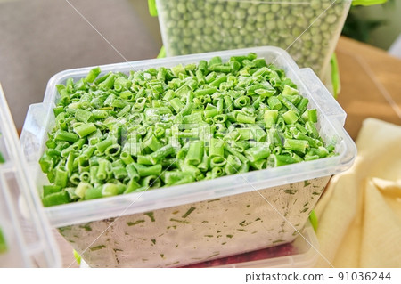 Frozen vegetables and fruits, close-up frozen green onions, peas 91036244