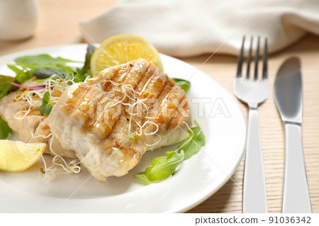 Tasty grilled fish served on wooden table, closeup Tasty grilled fish served on wooden table, closeup 91036342