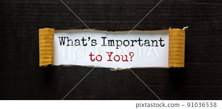 The words 'what is important to you' appearing behind torn black paper. Beautiful background. Business concept. 91036538