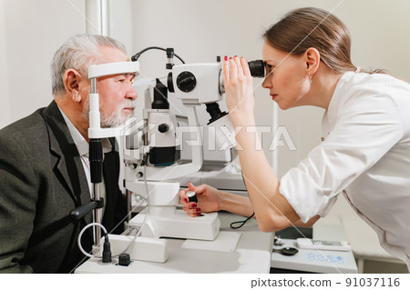 ophthalmologist examination of elderly man with slit lamp. medical equipment 91037116