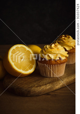 lemon muffins on a dark background lemon muffins on a dark background 91037424