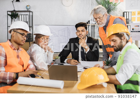 Qualified architects, engineers and designers discussing project plan in details during session Qualified architects, engineers and designers discussing project plan in details during session 91038147