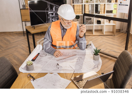 Positiv bearded mature man wearing orange reflective vest, and construction hard hat. 91038346