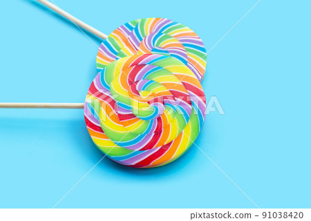 Rainbow lollipop on blue background. Rainbow lollipop on blue background. 91038420