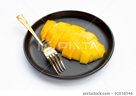 Yellow mango slices in plate on white background. 91038546