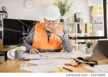 Architect mature man or male builder hold pen and ruler, writing and drawing architectural project. Architect mature man or male builder hold pen and ruler, writing and drawing architectural project. 91038690