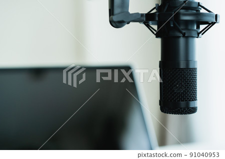 Home sound recording studio and equipment including professional condenser microphone and laptop computer for audio mixing. Digital audio sound recording studio at home. 91040953