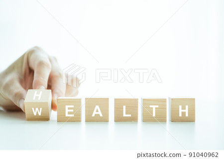 Words Health and Wealth on the wooden block close up, man turning the words between health and wealth. The conceptual of healthcare - wellbeing and security in financial. 91040962