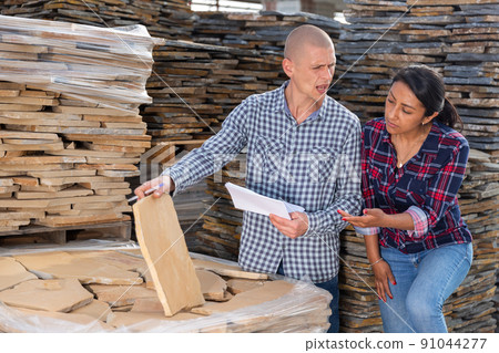 Buyers choose natural stone tiles in the open area of hardware store Buyers choose natural stone tiles in the open area of hardware store 91044277
