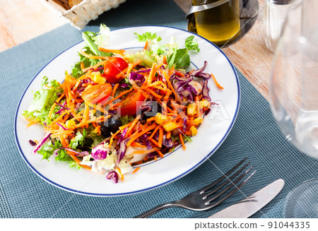 Plate of delicious salad made from lettuce, tomatoes, corn, onions Plate of delicious salad made from lettuce, tomatoes, corn, onions 91044335