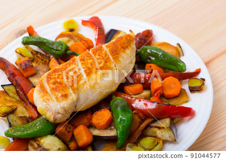 Top view of tasty baked different vegetables with chicken fillet 91044577