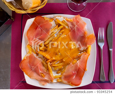 Scrambled eggs with ham and french fries Scrambled eggs with ham and french fries 91045254