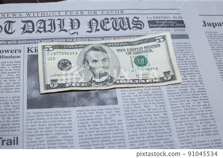 US $ 5 bill placed in an English newspaper US $ 5 bill placed in an English newspaper 91045534