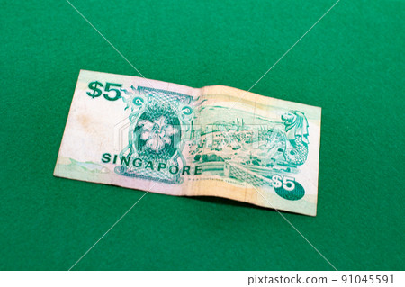 Singapore dollar on green background, 5 dollar bill 91045591