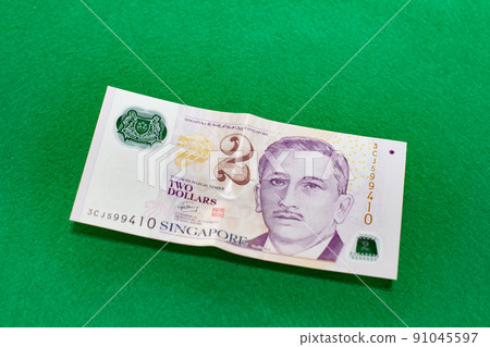 Singapore dollar on green background, 2 dollar bill 91045597