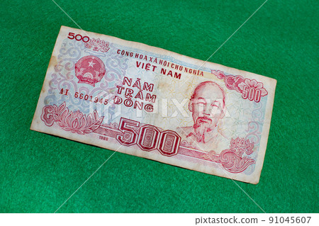 Vietnamese dong banknotes on green background 91045607